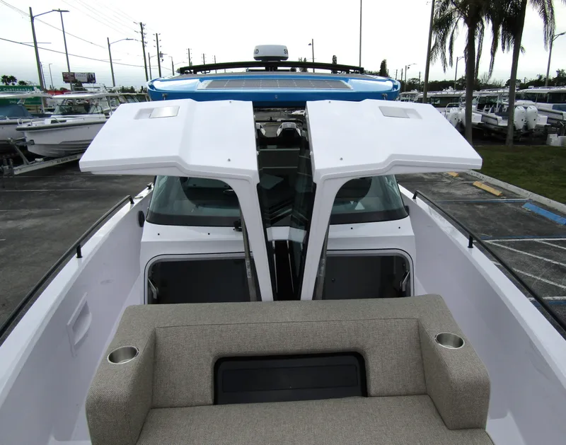Slide: The Image of 2024 Axopar 37 Sun Top boat with open deck and seating area. - 19