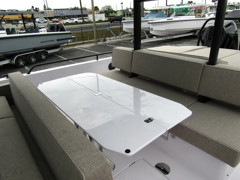 Slide: The Image of 2024 Axopar 37 Sun Top boat interior with seating and table. - 23