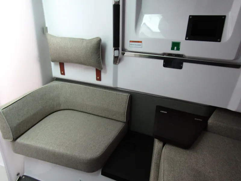 Slide: The Image of 2024 Axopar 37 Sun Top interior seating area with modern design and comfortable cushions. - 36