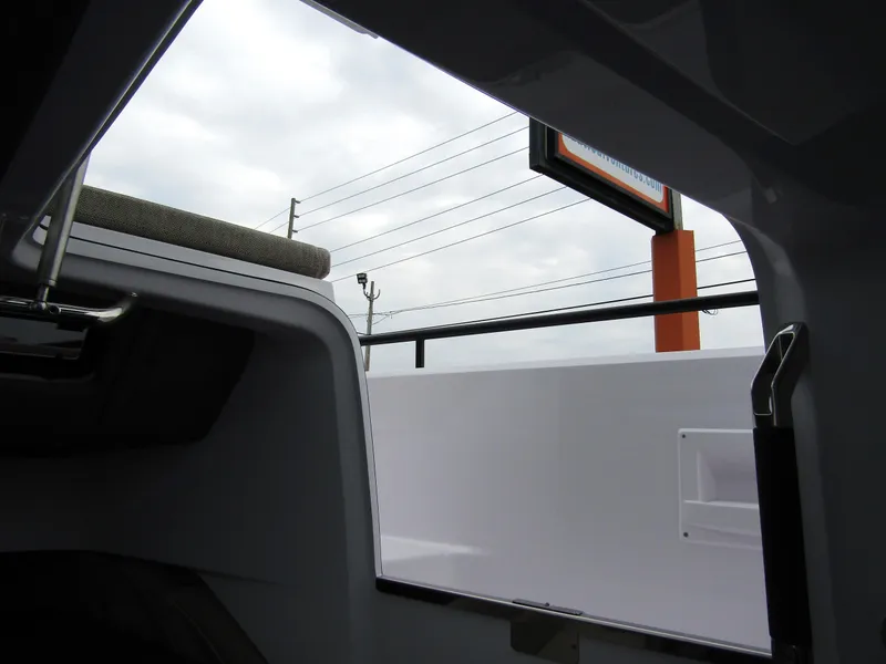 Slide: The Image of View from inside a 2024 Axopar 37 Sun Top boat, showing exterior details. - 21