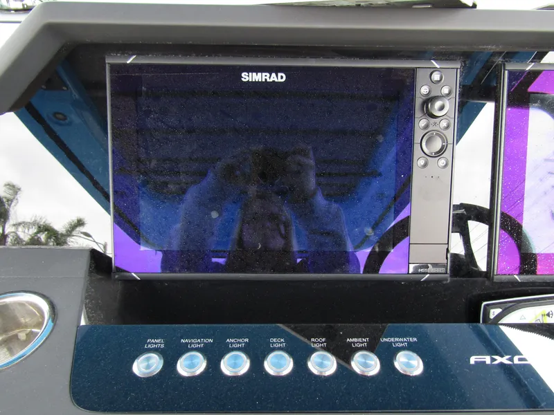 Slide: The Image of Simrad display and controls on 2024 Axopar 37 Sun Top boat dashboard. - 26