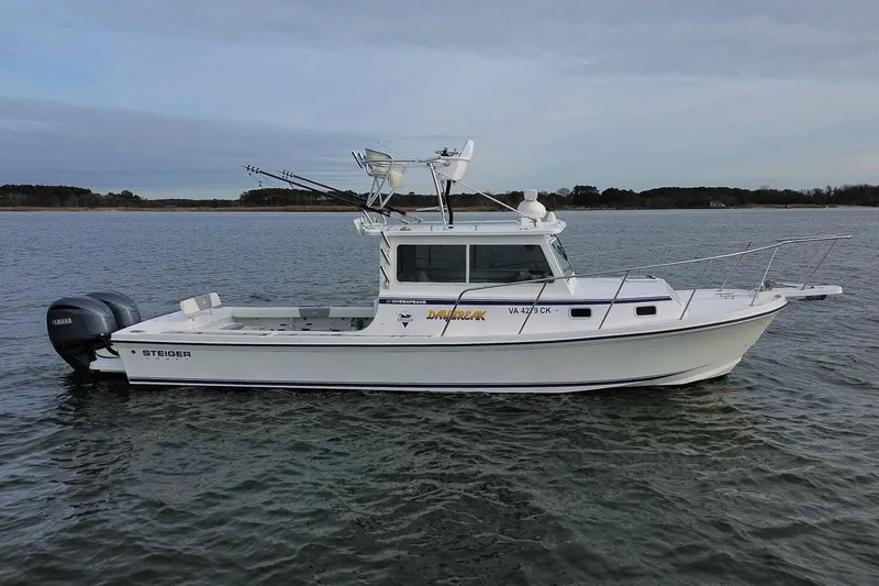 The Image of 2023 Steiger Craft 31 Chesapeake boat on calm water, side view. - 1