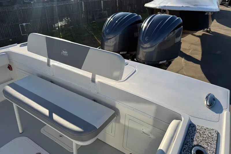 Slide: The Image of 2023 Steiger Craft 31 Chesapeake boat with dual Yamaha engines and seating area. - 10
