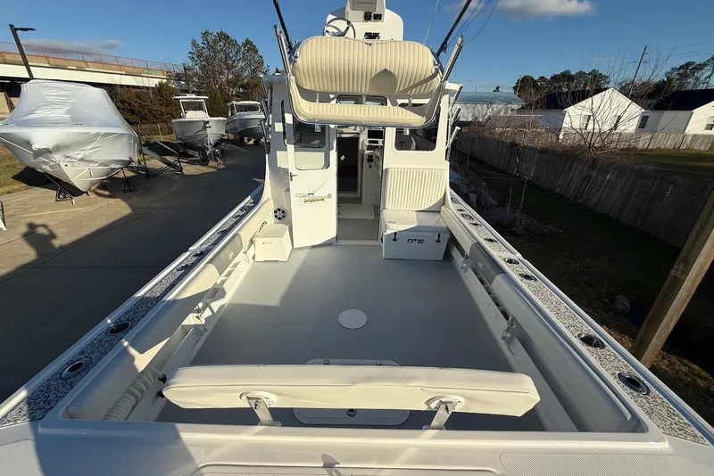 Slide: The Image of 2023 Steiger Craft 31 Chesapeake boat with spacious deck and seating, docked outdoors. - 16