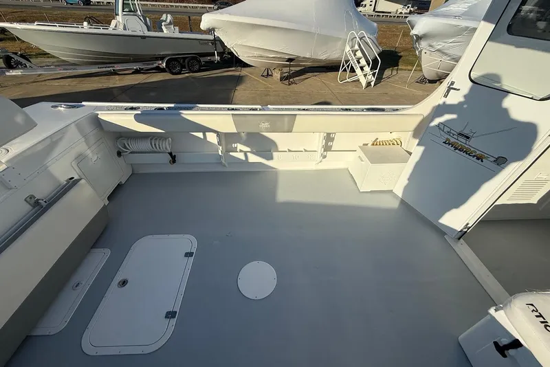 Slide: The Image of 2023 Steiger Craft 31 Chesapeake boat deck with storage compartments and fishing gear. - 17