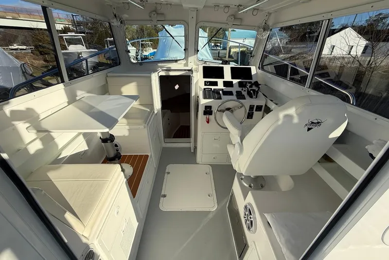 Slide: The Image of Interior of 2023 Steiger Craft 31 Chesapeake boat, featuring helm and seating area. - 20