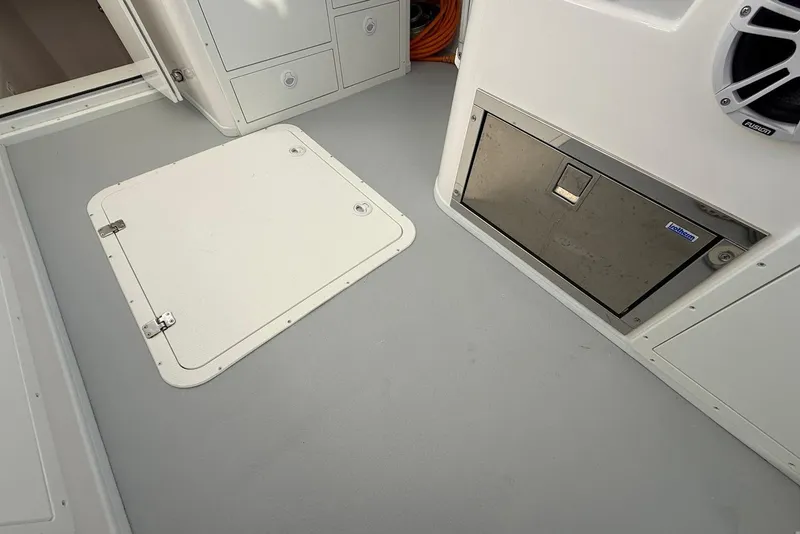 Slide: The Image of Interior of 2023 Steiger Craft 31 Chesapeake boat, featuring storage compartments and hatch. - 23