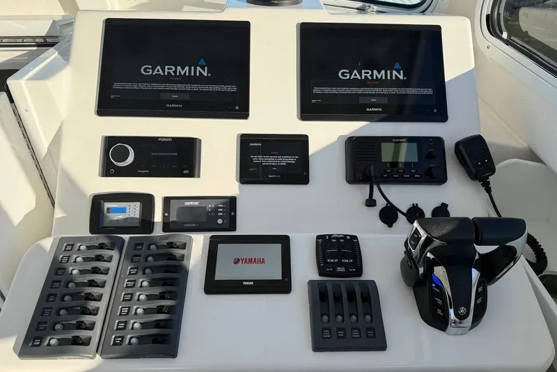 Slide: The Image of Steiger Craft 31 Chesapeake 2023 dashboard with Garmin displays and Yamaha controls. - 27