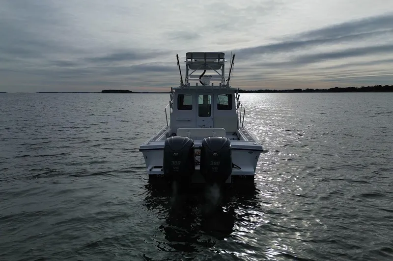 Slide: The Image of 2023 Steiger Craft 31 Chesapeake boat on calm water at sunset. - 3