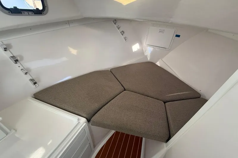 Slide: The Image of 2023 Steiger Craft 31 Chesapeake cabin interior with cushioned seating and white walls. - 34