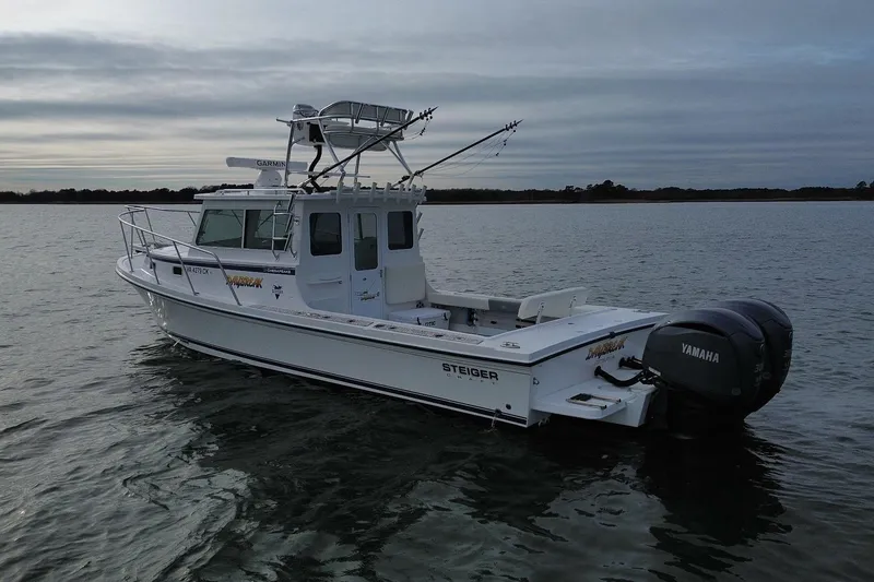 Slide: The Image of 2023 Steiger Craft 31 Chesapeake boat on calm water with Yamaha engines. - 4