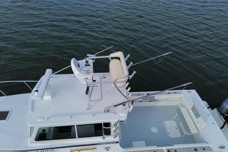 Slide: The Image of 2023 Steiger Craft 31 Chesapeake boat with fishing setup on calm water. - 5