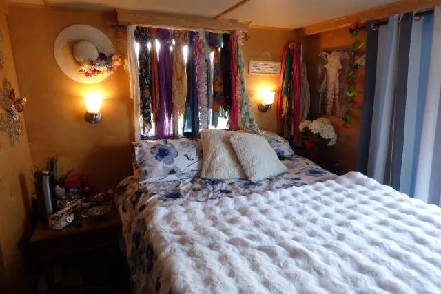 Slide: The Image of Cozy bedroom in 1978 Lazy Days 14x57 houseboat with floral decor and soft lighting. - 8
