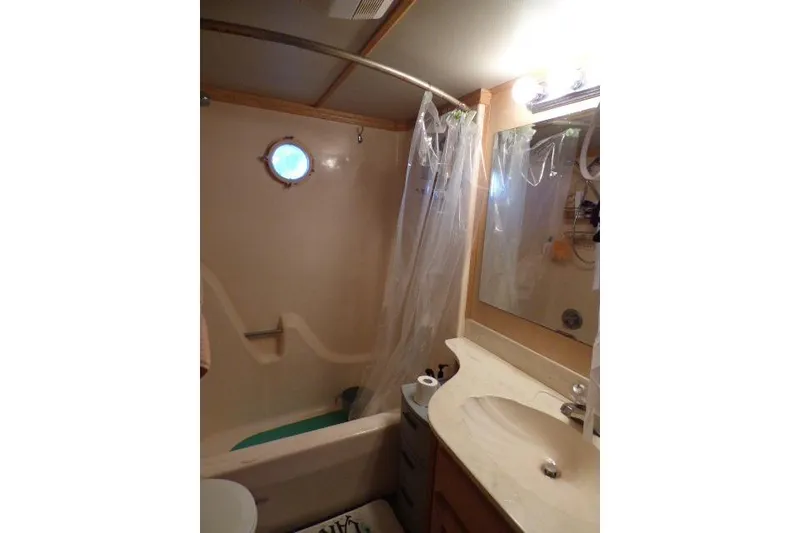 Slide: The Image of Bathroom interior of a 1978 Lazy Days 14x57 houseboat with shower and vanity. - 9