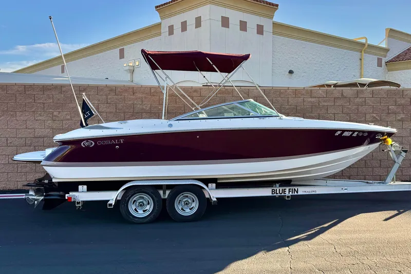 The Image of 2006 Cobalt 220 boat on Blue Fin trailer, parked outdoors. - 0