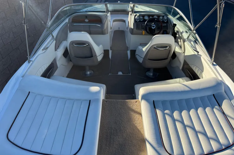 Slide: The Image of Interior of a 2006 Cobalt 220 boat with white seating and steering console. - 10