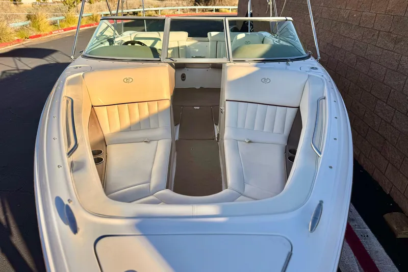 Slide: The Image of 2006 Cobalt 220 boat with white interior, parked outdoors. - 11
