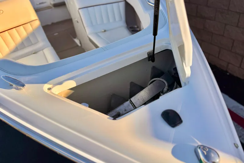 Slide: The Image of Open storage compartment on a 2006 Cobalt 220 boat, showing interior details. - 13
