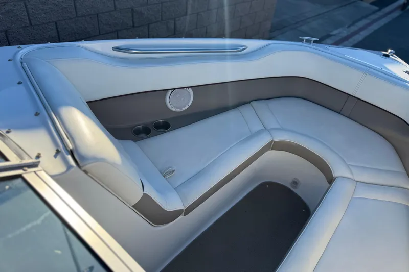 Slide: The Image of 2006 Cobalt 220 boat interior with white cushioned seating and speaker. - 15