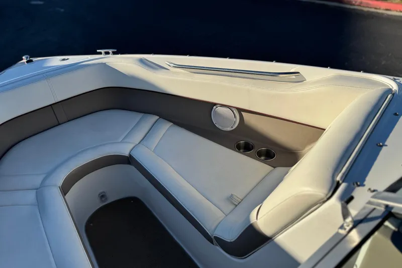 Slide: The Image of Interior of a 2006 Cobalt 220 boat with white seating and cup holders. - 16
