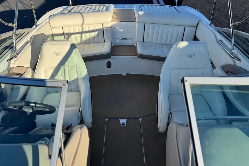 Slide: The Image of 2006 Cobalt 220 boat interior with white leather seats and spacious layout. - 19