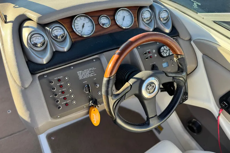 Slide: The Image of 2006 Cobalt 220 boat dashboard with gauges and steering wheel. - 29