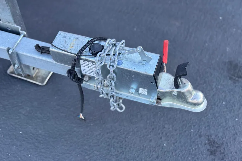 Slide: The Image of Trailer hitch with safety chains on a 2006 Cobalt 220 boat trailer. - 32