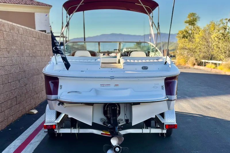 Slide: The Image of 2006 Cobalt 220 boat on trailer, rear view, with maroon accents and canopy. - 4