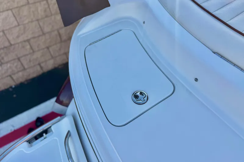 Slide: The Image of 2006 Cobalt 220 boat deck with storage compartment and latch. - 7