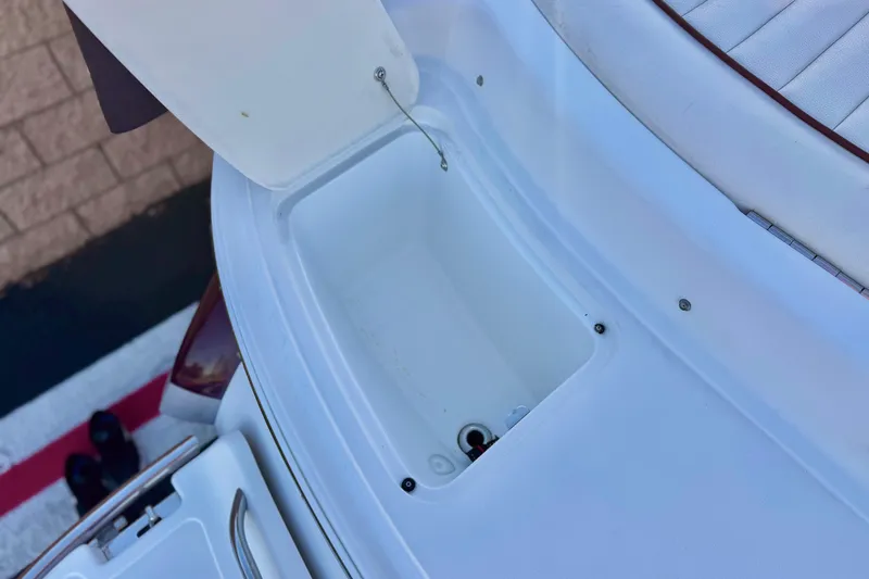 Slide: The Image of Open storage compartment on a 2006 Cobalt 220 boat, featuring white interior. - 8