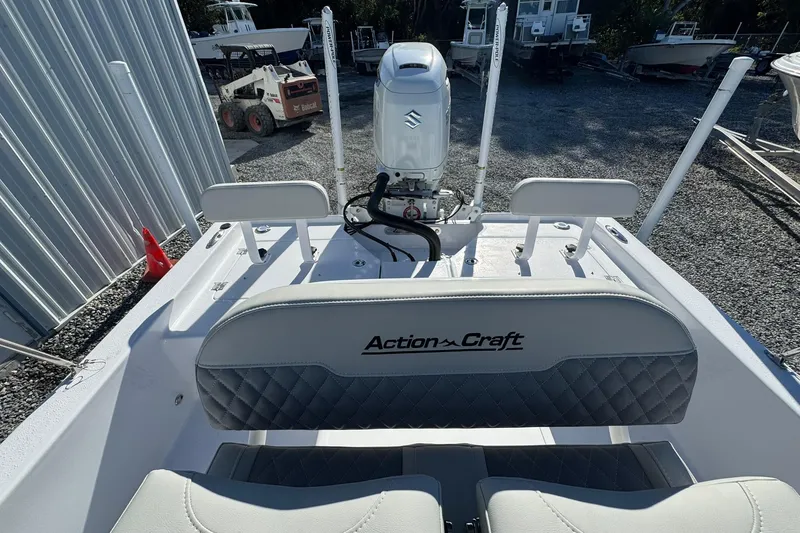Slide: The Image of 2026 Action Craft 22 Coastal Bay boat with Suzuki outboard motor, docked outdoors. - 10
