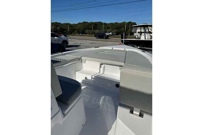 Slide: The Image of 2026 Action Craft 22 Coastal Bay boat interior with cushioned seating and storage compartments. - 11
