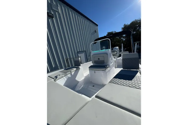 Slide: The Image of 2026 Action Craft 22 Coastal Bay boat, sleek design, outdoor setting, sunny day. - 5