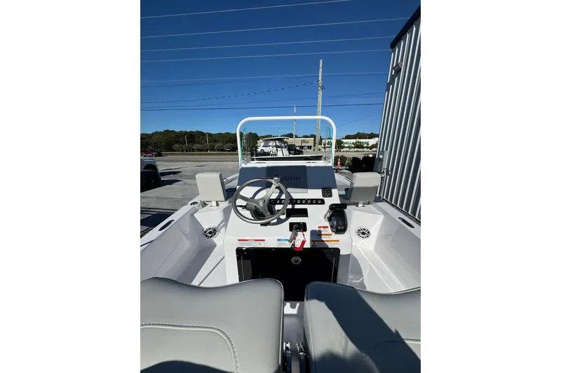 Slide: The Image of 2026 Action Craft 22 Coastal Bay boat interior with steering wheel and navigation system. - 8