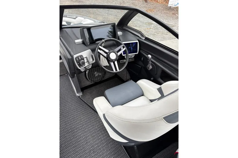 Slide: The Image of 2016 Malibu Wakesetter 25 LSV cockpit with modern steering and control panels. - 11
