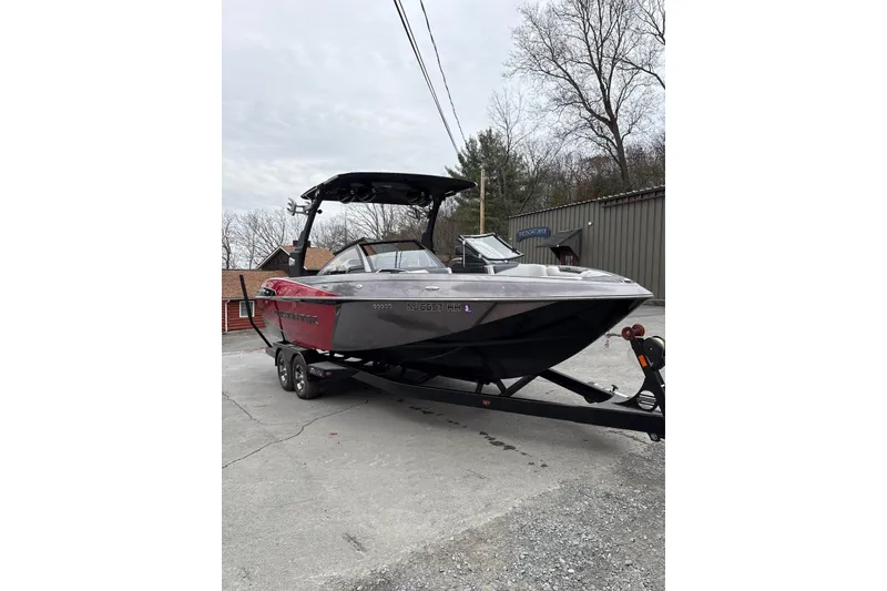 Slide: The Image of 2016 Malibu Wakesetter 25 LSV boat on trailer, parked outdoors. - 3