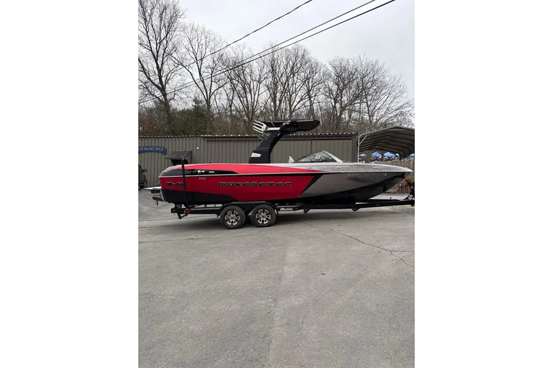 Slide: The Image of 2016 Malibu Wakesetter 25 LSV boat in red and black on trailer. - 4