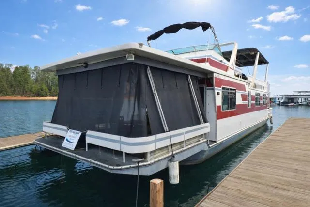 The Image of 1987 Sumerset 14x64 houseboat docked on a sunny day with clear skies. - 0