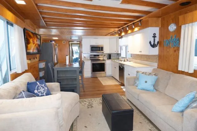 Slide: The Image of Cozy 1987 Sumerset 14x64 houseboat interior with modern kitchen and comfortable living area. - 2