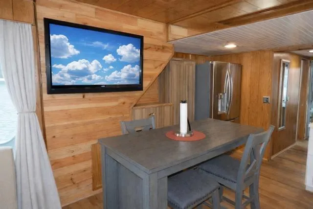 Slide: The Image of Interior of 1987 Sumerset 14x64 houseboat with modern kitchen and wall-mounted TV. - 5