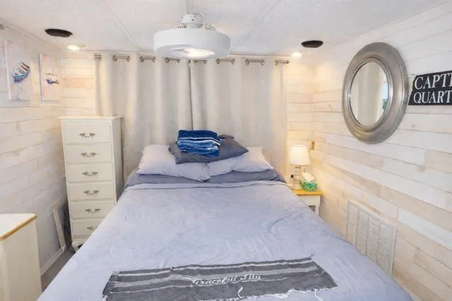 Slide: The Image of Cozy bedroom in 1987 Sumerset 14x64 houseboat with nautical decor and soft lighting. - 7