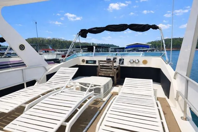 Slide: The Image of 1987 Sumerset 14x64 houseboat deck with lounge chairs and scenic lake view. - 9