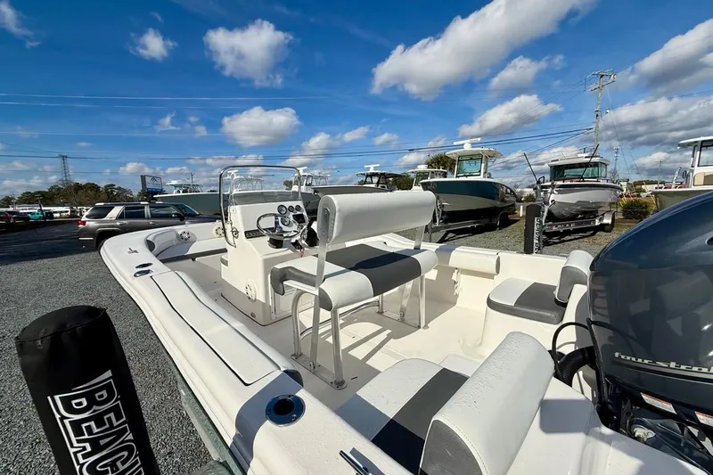Slide: The Image of 2020 Tidewater 180 CC Adventure boat with seating, console, and outboard motor under blue sky. - 12