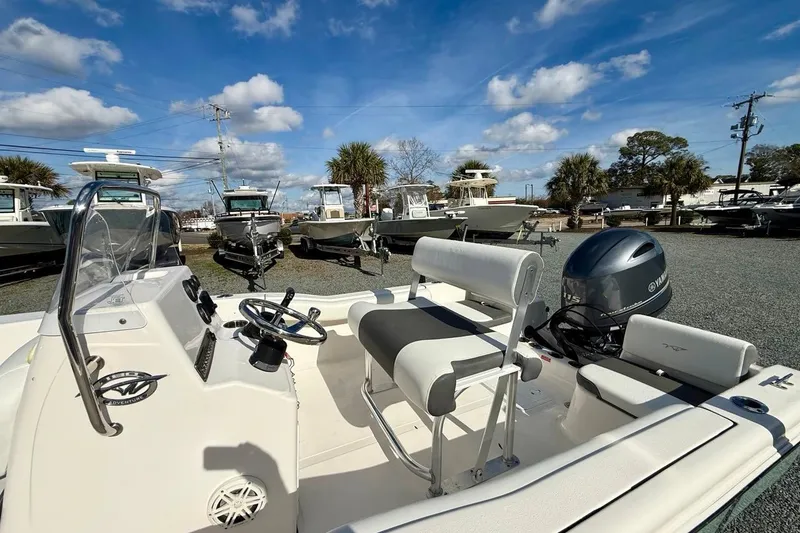 Slide: The Image of 2020 Tidewater 180 CC Adventure boat with Yamaha engine, parked outdoors under a blue sky. - 13