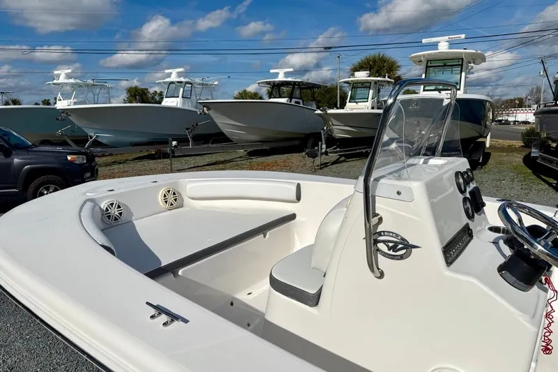 Slide: The Image of 2020 Tidewater 180 CC Adventure boat displayed outdoors with other boats in the background. - 14