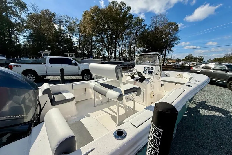 Slide: The Image of 2020 Tidewater 180 CC Adventure boat with seating and console, parked outdoors. - 15