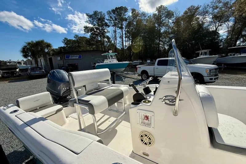 Slide: The Image of 2020 Tidewater 180 CC Adventure boat with Yamaha engine, parked outdoors under clear sky. - 16