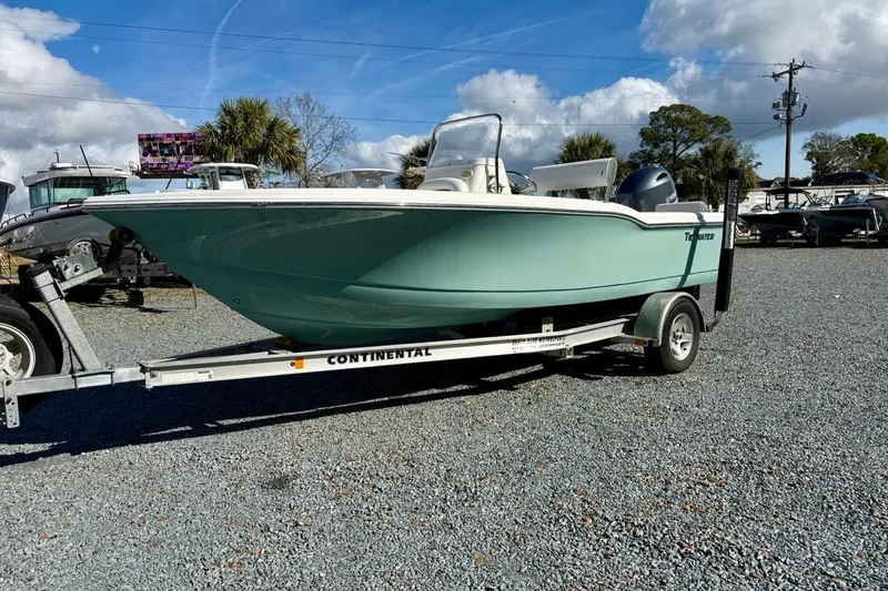 Slide: The Image of 2020 Tidewater 180 CC Adventure boat on trailer, parked outdoors under blue sky. - 8