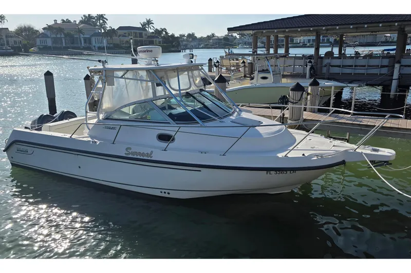 The Image of 2001 Boston Whaler 275 Conquest boat docked in sunny marina setting. - 0