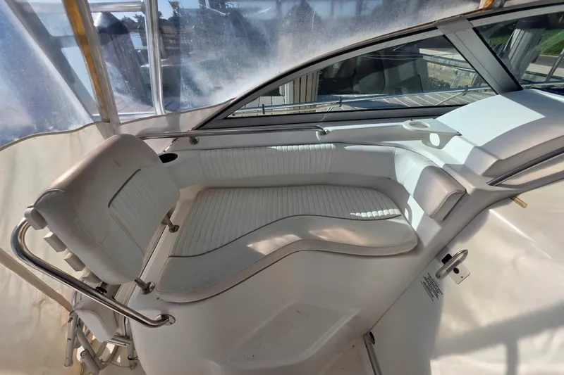 Slide: The Image of 2001 Boston Whaler 275 Conquest interior seating with white upholstery and sleek design. - 11